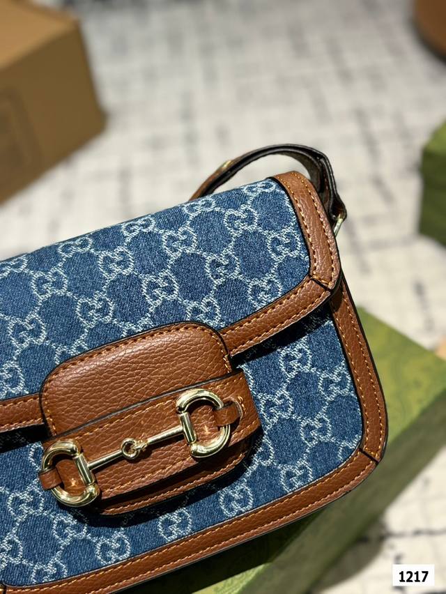 The Gucci 1955 horseneck buckle handbag, packaged in a gift box, made a stunning debut in the early spring collection. This handbag continues the lines and styling of classic items from over sixty years ago, cleverly blending classic details with mod